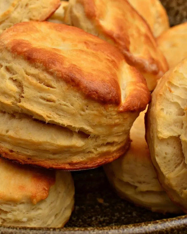 Golden baked biscuits piled on a plate