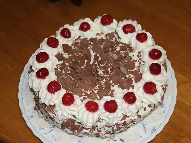 Black Forest cake with cream rosettes, cherries and chocolate shavings