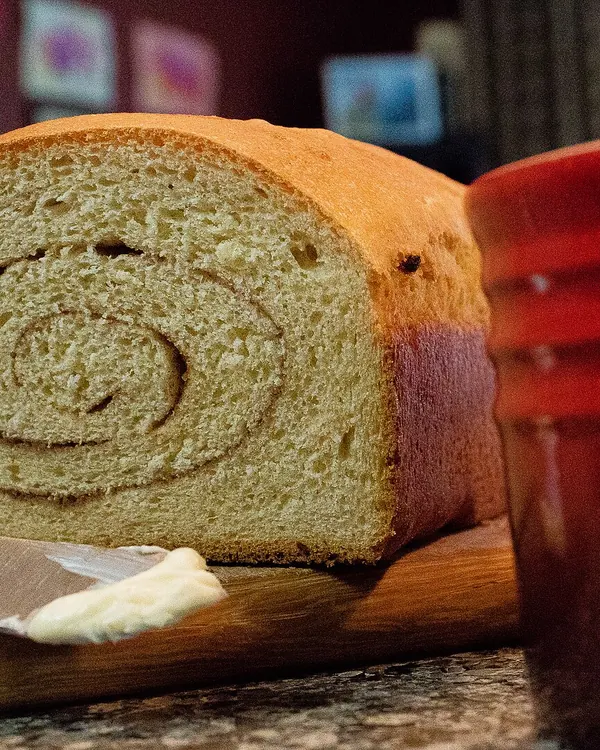 Sliced loaf with a cinnamon swirl on a board