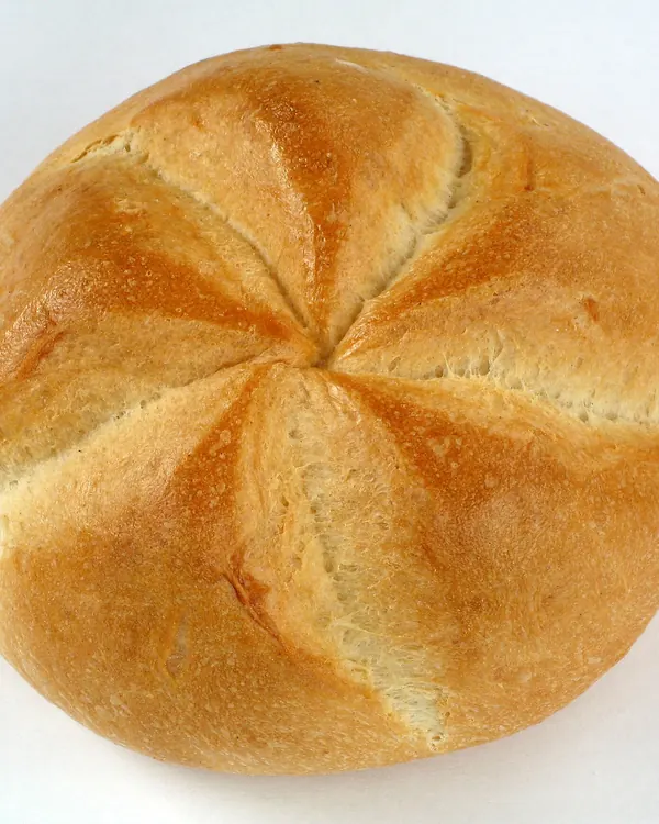 Kaiser roll with its five-part swirl, on white