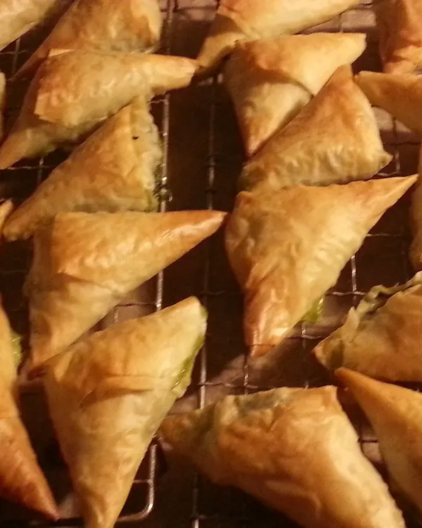 Golden phyllo pastries on a rack